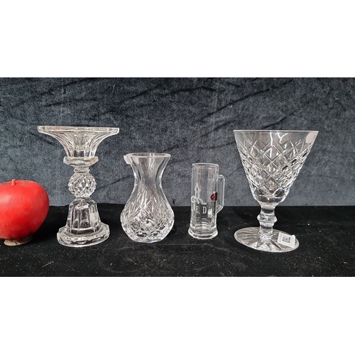 780 - Four crystal pieces, including one Waterford Crystal glass with acid mark to base, a cut glass candl... 