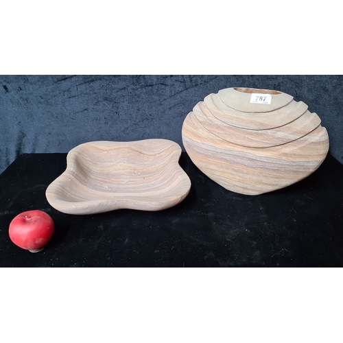 787 - A set of two sandstone decorative pieces including a wave-shaped bowl and a tiered vase, both with n... 