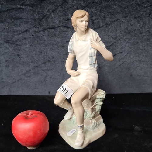 791 - A Lladro porcelain figurine of a seated girl in sports attire, marked 