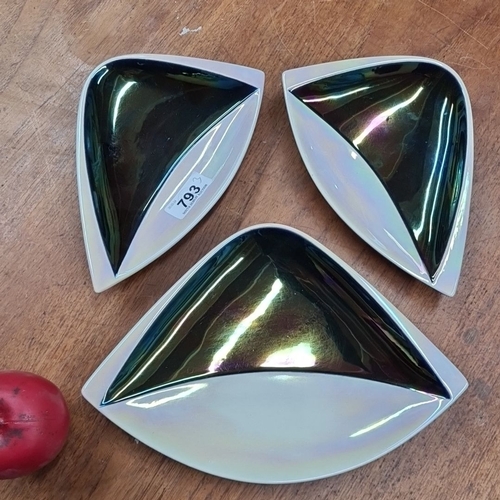 793 - A group of three iridescent ceramic triangular dishes. Marked with 