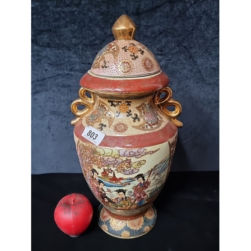 803 - Japanese Kutani-style lidded porcelain vase featuring intricate hand-painted scenes with gold accent... 