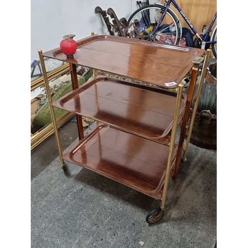 844 - A vintage Platex textable laminated three-tier folding trolley Doree Gnarl. Equipped with wheels for... 