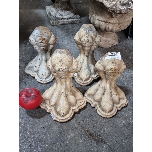 851 - Set of four cast iron bath feet with ornate detailing, likely from the Victorian period. Cream-toned... 