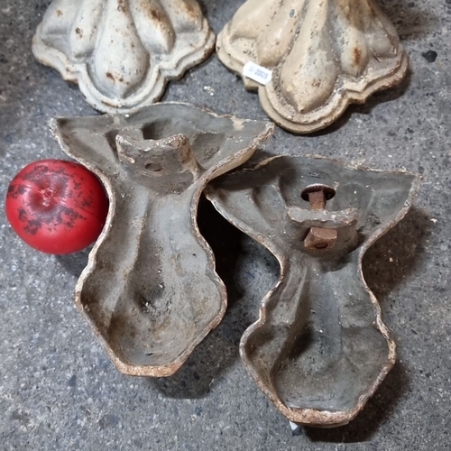 851 - Set of four cast iron bath feet with ornate detailing, likely from the Victorian period. Cream-toned... 