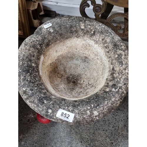 852 - Antique stone garden urn with a weathered patina, featuring a scalloped rim and pedestal base. Ideal... 