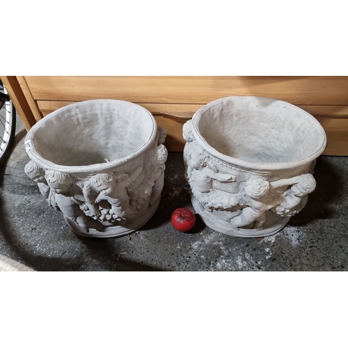 857 - Pair of white cement planters with decorative cherub relief. Stylish garden or outdoor decor. Measur... 