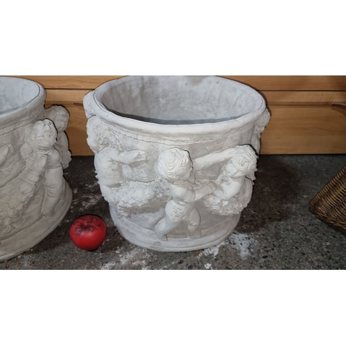 857 - Pair of white cement planters with decorative cherub relief. Stylish garden or outdoor decor. Measur... 