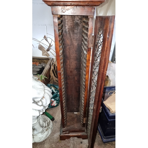 861 - A mahogany spindle-front CD rack. Features an intricately carved door with interior slots designed f... 