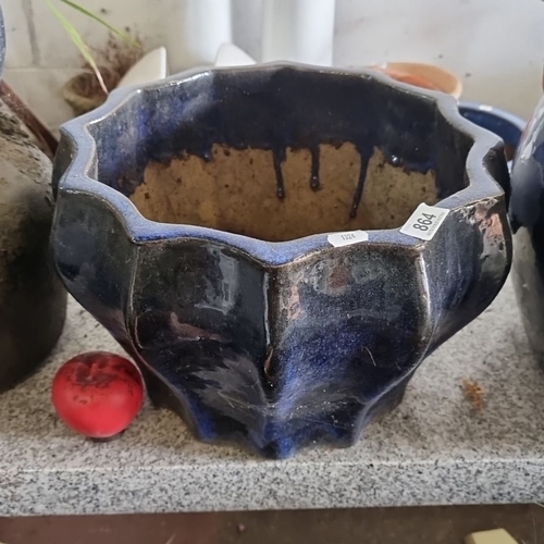 864 - Handcrafted ceramic planter with a scalloped, fluted rim. Features a unique dark blue glaze with nat... 