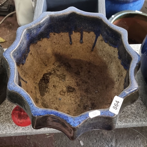 864 - Handcrafted ceramic planter with a scalloped, fluted rim. Features a unique dark blue glaze with nat... 