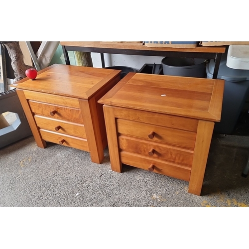 874 - A pair of wooden nightstands with three drawers each, crafted from solid wood with natural finish an... 