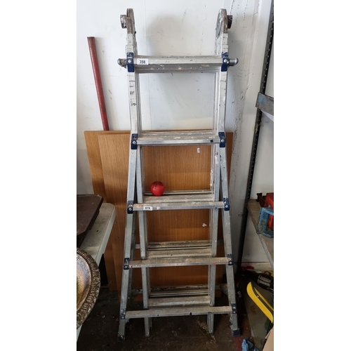 879 - An NTS multi-position aluminum ladder with multiple locking mechanisms and compact folding design.