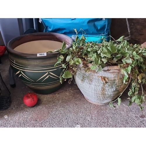 883 - Two outdoor planter pots. Includes one green toned patterned ceramic planter and one textured white ... 