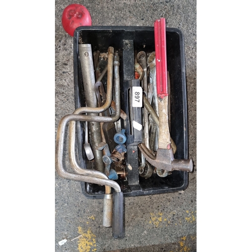 897 - A box of assorted tools including wrenches, clamps, a hammer, and various metal fittings.