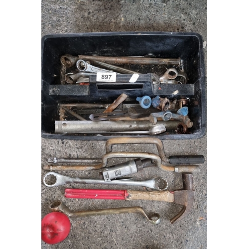 897 - A box of assorted tools including wrenches, clamps, a hammer, and various metal fittings.