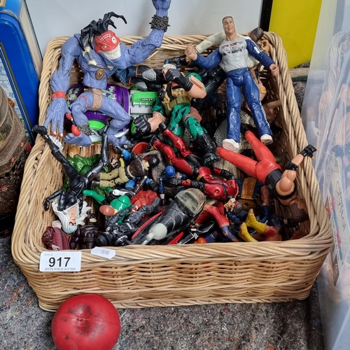 917 - A basket containing a selection of children's action figures including some wrestler examples.