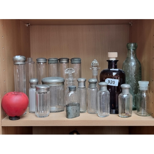 920 - A fine array of vintage glass bottles including silver plated topped perfume examples.