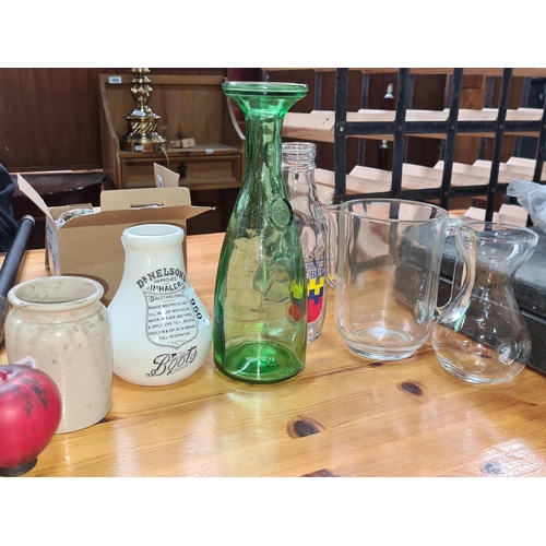 950 - Six vintage items including a commemorative Dublin 1988 glass milk bottle, an emerald green water de... 