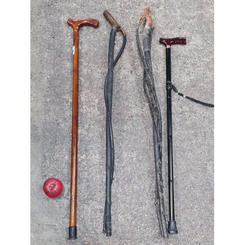 960 - Four walking sticks including a metal adjustable examples , two with interesting twist design and on... 