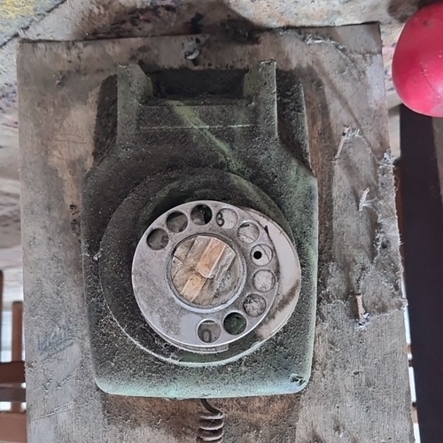 786 - A vintage part A/B  rotary dial telephone mounted on wooden plank. Mid-20th century. Distinctive gre... 