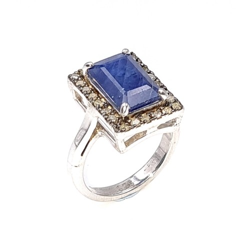 40 - Star Lot : A stunning large natural sapphire facet cut gemstone ring with diamond surround set in st... 