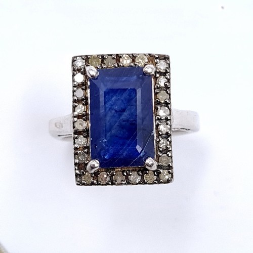 40 - Star Lot : A stunning large natural sapphire facet cut gemstone ring with diamond surround set in st... 