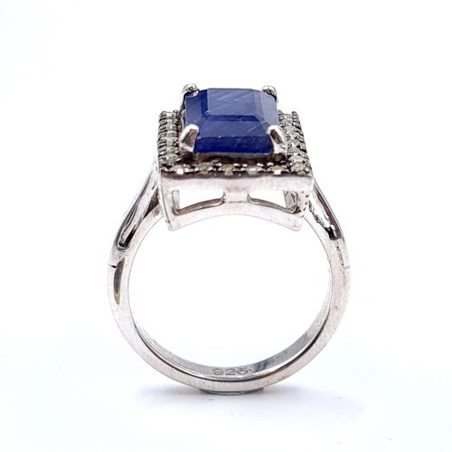 40 - Star Lot : A stunning large natural sapphire facet cut gemstone ring with diamond surround set in st... 