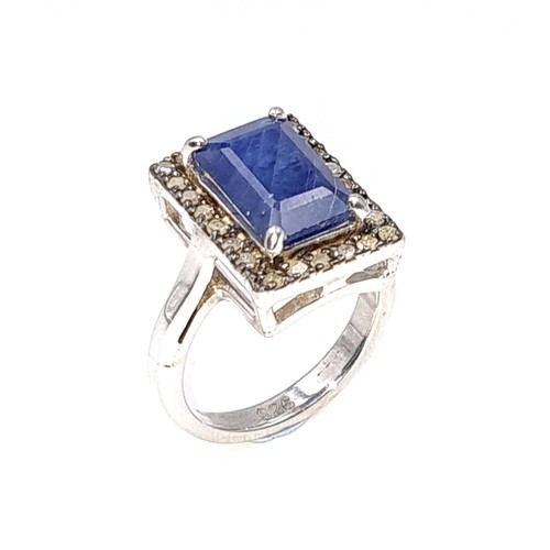 297 - A stunning large natural sapphire facet cut gemstone ring with diamond surround set in sterling silv... 