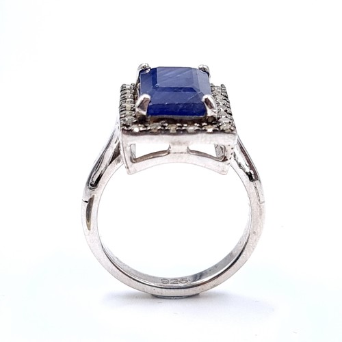 297 - A stunning large natural sapphire facet cut gemstone ring with diamond surround set in sterling silv... 