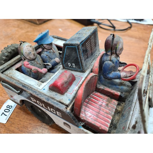 733 - A vintage DAIYA tin police jeep with figures, made in Japan. Marked 