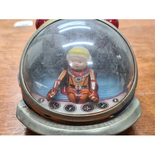 740 - Star Lot : A vintage tinplate toy rocket 'Atom Rocket 7' by Modern Toys, Japan. Features astronaut p... 