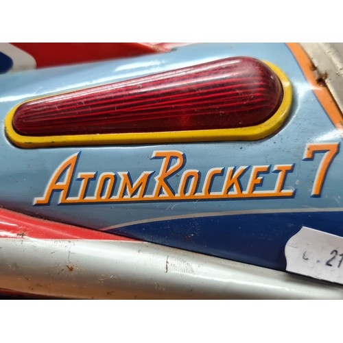 740 - Star Lot : A vintage tinplate toy rocket 'Atom Rocket 7' by Modern Toys, Japan. Features astronaut p... 