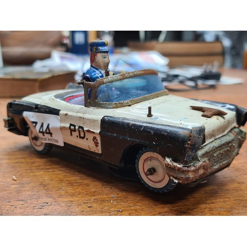 744 - A vintage Japanese Tin Toy Police Car, K.O. Brand, Model 4356. Detailed officer driver in blue unifo... 