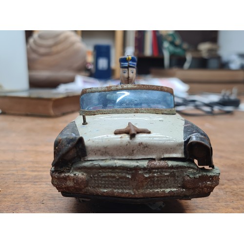 744 - A vintage Japanese Tin Toy Police Car, K.O. Brand, Model 4356. Detailed officer driver in blue unifo... 