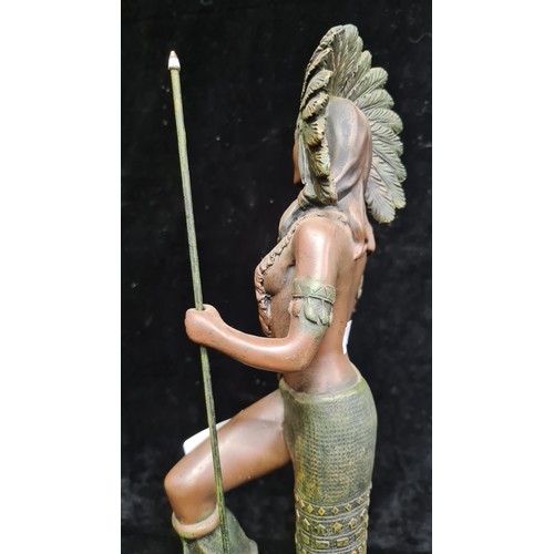 223 - An elegant poised figure of an Indian Squaw wearing a traditional head piece and with hunting spear.... 