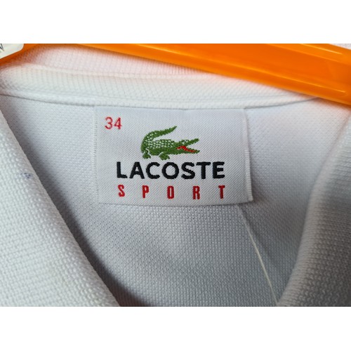 294 - A brand new Lacoste Sport Tennis Dress, size 34, white and royal blue with pleated detail, new with ... 