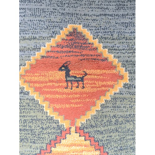 295 - A lovely large  rug featuring animal and geometric design. In tones of blue, green and orange. MM 22... 