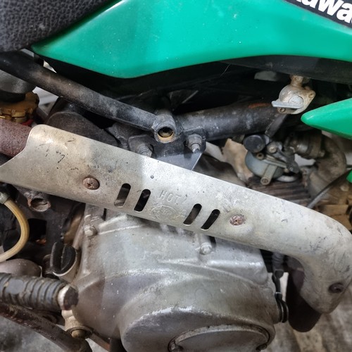 650 - Star Lot: Kawasaki dirt bike with green body and Monster Energy branding. Engine close-up detailing ... 