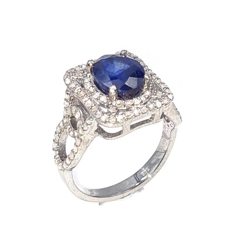 975 - Star Lot : A fine example of a natural sapphire and diamond ring mounted in sterling silver. Ring si... 