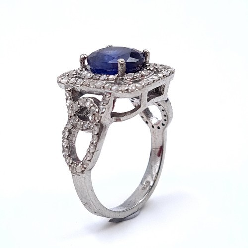 975 - Star Lot : A fine example of a natural sapphire and diamond ring mounted in sterling silver. Ring si... 