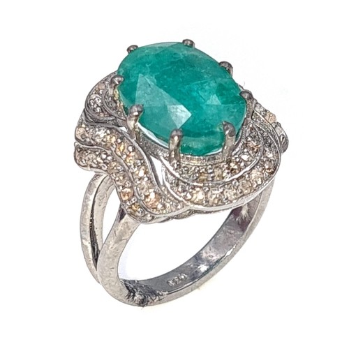 976 - Star lot : A fabulous huge natural emerald gemstone ring with diamond surround mounted in sterling s... 