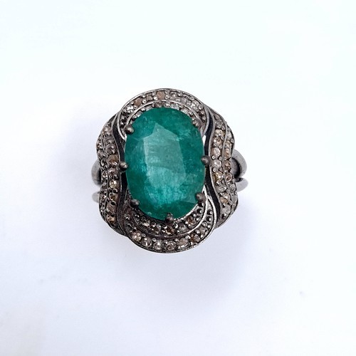 976 - Star lot : A fabulous huge natural emerald gemstone ring with diamond surround mounted in sterling s... 