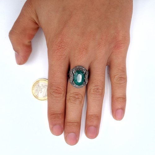 976 - Star lot : A fabulous huge natural emerald gemstone ring with diamond surround mounted in sterling s... 