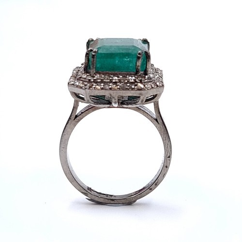 977 - Star lot : A fabulous huge natural emerald gemstone ring with diamond surround mounted in sterling s... 