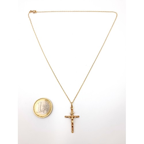 1 - A nine carat gold crucifix cross and chain. Cross dimensions: 3 x 1.5 cms. Length of chain - 48 cms.... 