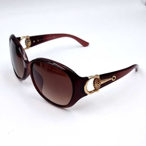 545 - A super pair of Gucci sunglasses marked 'Made in Italy' set with gold accents to frames. Together wi... 