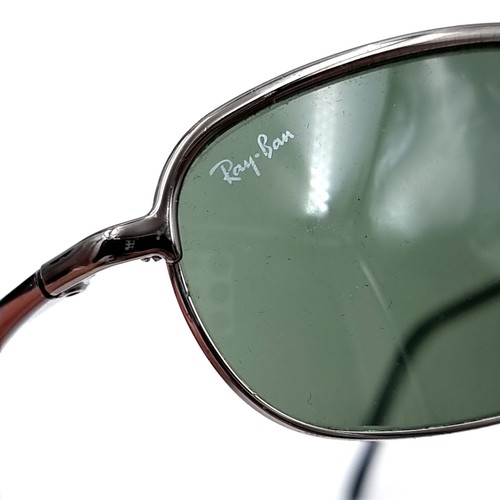 559 - A pair of original Ray-Ban as new sunglasses marked 'Made in Italy'. Comes with leather pouch.