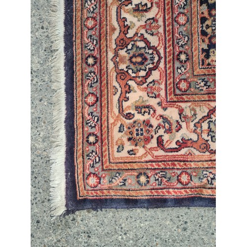 845 - STAR LOT : A Persian hand-knotted wool rug featuring intricate floral motifs and vibrant geometric b... 