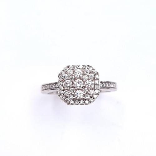 544 - Star lot : A nine carat white gold brilliant cut diamond cluster ring. Est. weight of diamond - 0.5 ... 