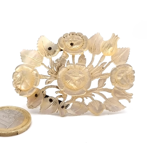 13 - An antique mother of pearl floral designed brooch. Dimensions - 6 x 4 cms. Weight - 17 grams. Pin in... 